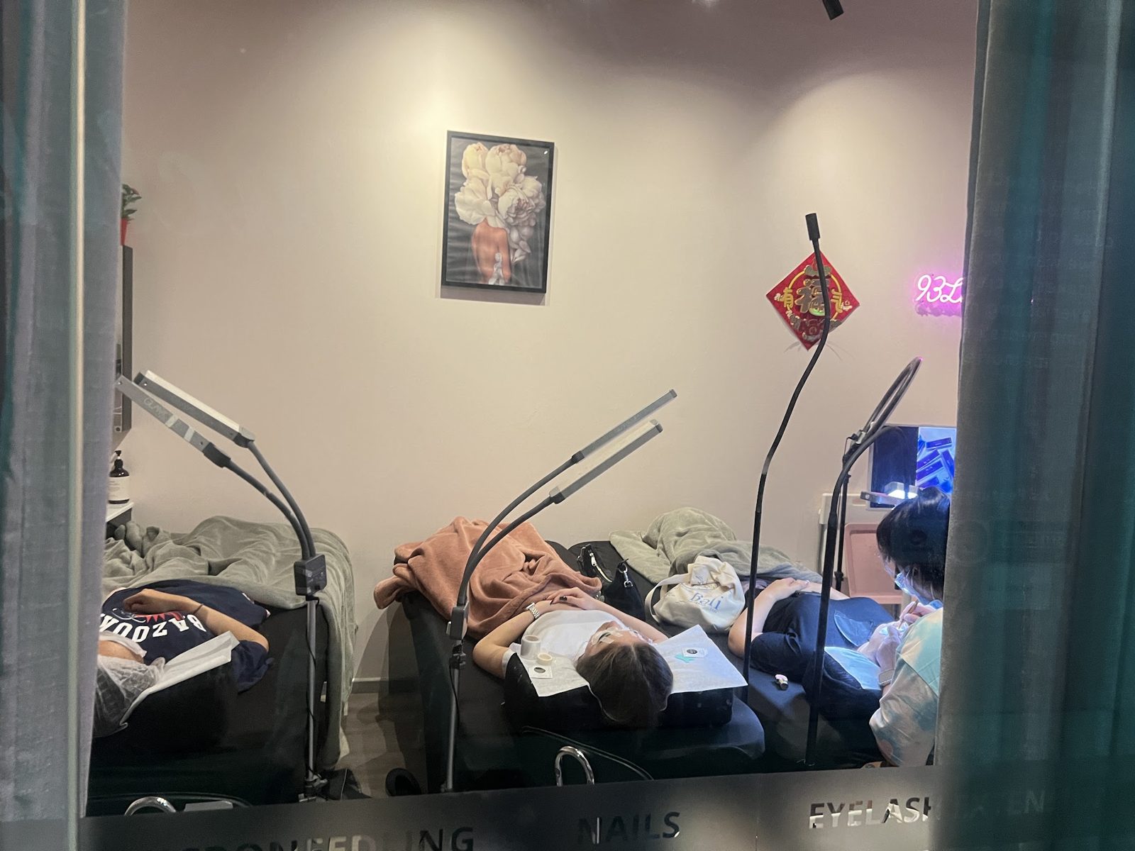 The treatment room with beds, lamps and a neon sign